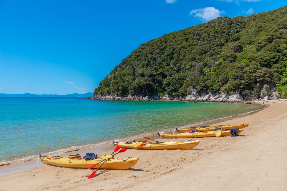 Yellow kayaks at Onetahuti beach at Abel Tasman national park in New Zealand